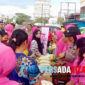 Petugas Polres Konawe dan ibu-ibu Bhayangkari aktif membagikan beras kepada warga saat pasar murah di depan Pasar Wawotobi, Kamis (15/8/2025). Sebanyak 4 ton beras SPHP dijual Rp58.000/5 kg, lebih murah dari harga pasar.