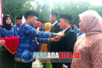 Momen haru Bupati Yusran Akbar menyematkan Satyalancana Karya Satya kepada salah satu ASN berprestasi saat Peringatan Hari Ulang Tahun (HUT) Ke-54 Korps Pegawai Republik Indonesia (KORPRI) Tingkat Kabupaten Konawe, Senin (1/12/2025)