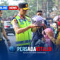 Kapolda Sultra Irjen Pol. Dr. Himawan Bayu Aji, S.H., S.I.K., M.H., memakaikan helm kepada seorang anak yang dibonceng sepeda motor, didampingi personel kepolisian lainnya